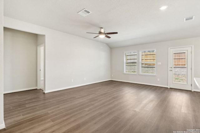 unfurnished room with dark wood-style floors, visible vents, ceiling fan, and baseboards