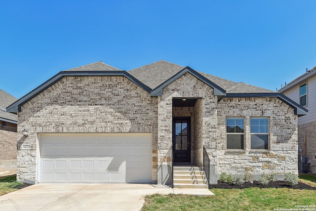 view of front of house with a front lawn and a garage