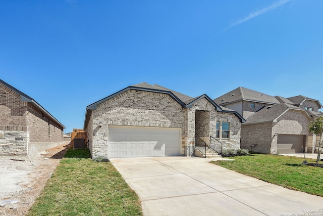 view of front facade featuring a front yard, a garage, and central AC