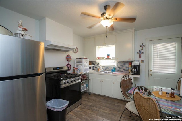 kitchen featuring white cabinets, appliances with stainless steel finishes, backsplash, and range hood