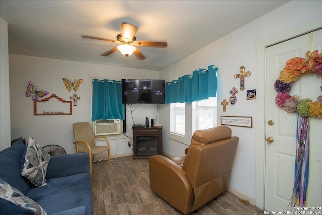 living room featuring a fireplace, hardwood / wood-style floors, ceiling fan, and cooling unit