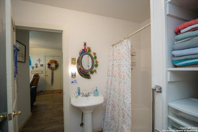 bathroom with curtained shower and wood-type flooring