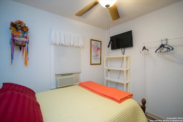 bedroom with ceiling fan and cooling unit