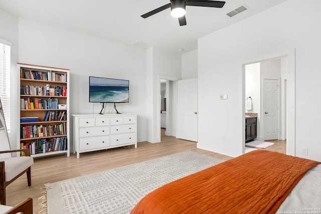 bedroom featuring ensuite bath, ceiling fan, and light hardwood / wood-style floors