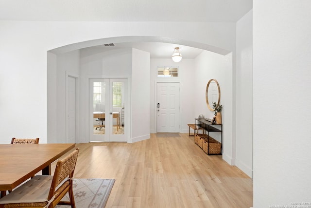 entryway with french doors and light hardwood / wood-style floors