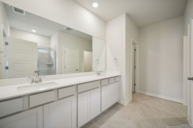 bathroom featuring walk in shower, tile patterned flooring, and vanity