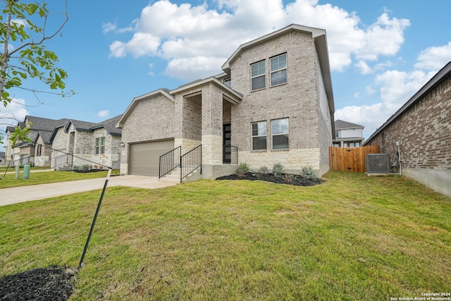 view of front of property with a garage, central AC, and a front lawn