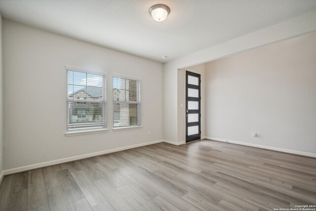 unfurnished room with light hardwood / wood-style floors