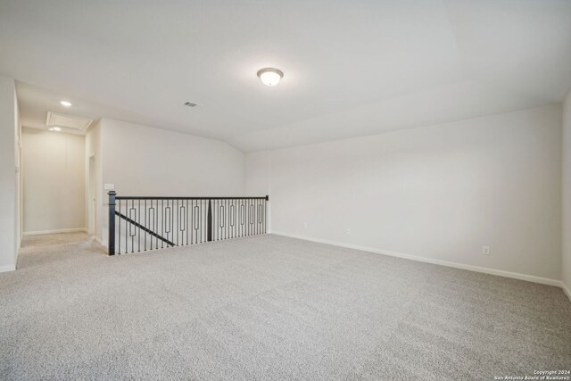 unfurnished room with lofted ceiling and light colored carpet