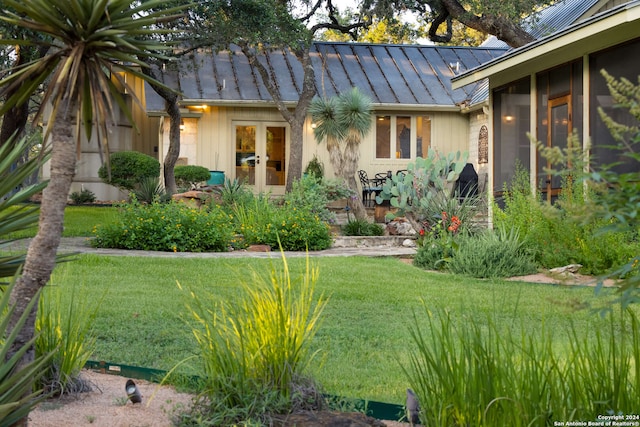 view of front of house featuring french doors and a front yard