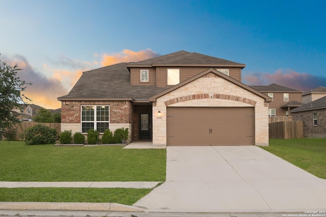 view of front of property featuring a lawn and a garage