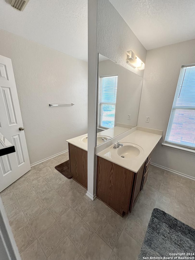 bathroom with vanity and a textured ceiling