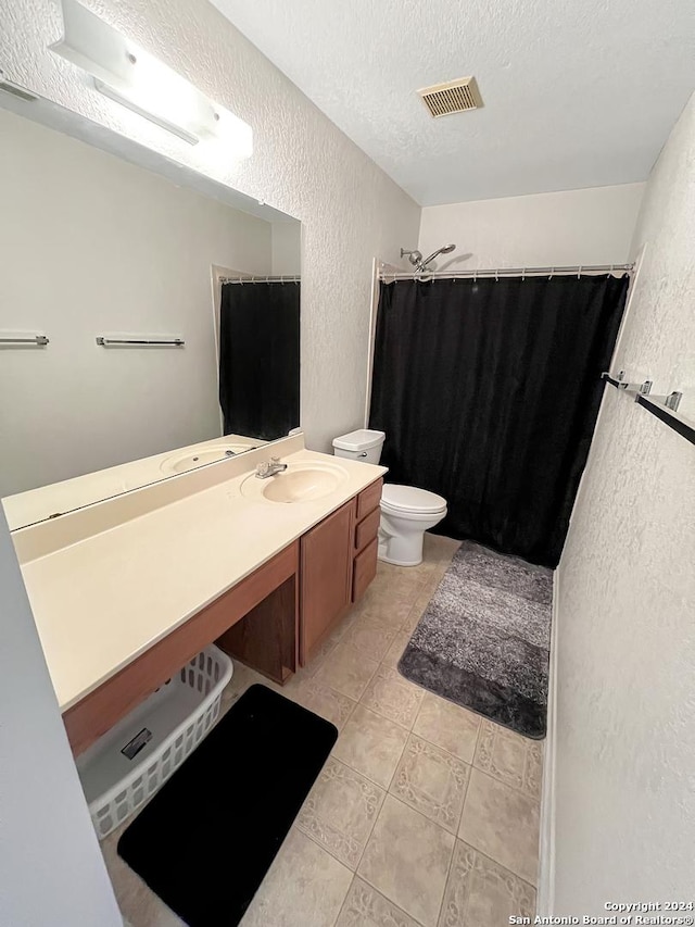 bathroom featuring vanity, a shower with curtain, a textured ceiling, and toilet