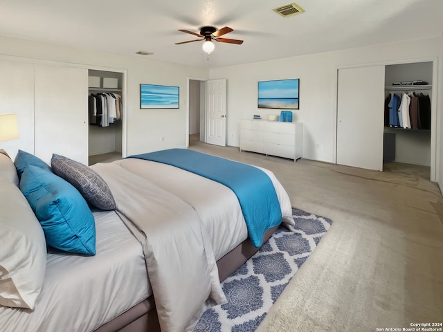 bedroom with two closets and ceiling fan