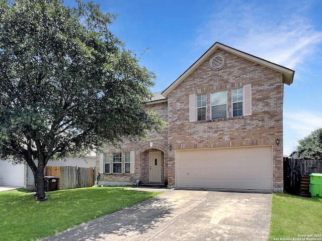 front facade featuring a garage and a front yard