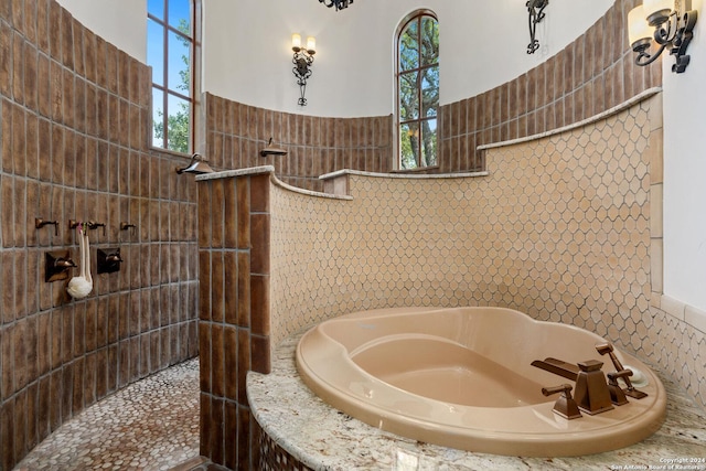 bathroom featuring shower with separate bathtub