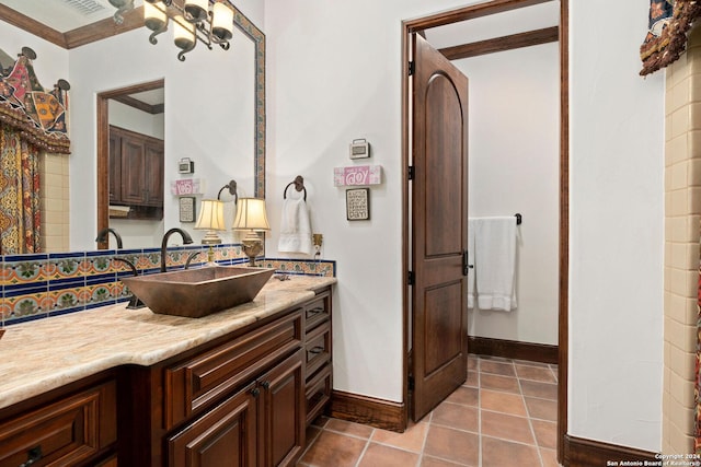 bathroom with tile patterned flooring, decorative backsplash, vanity, and ornamental molding