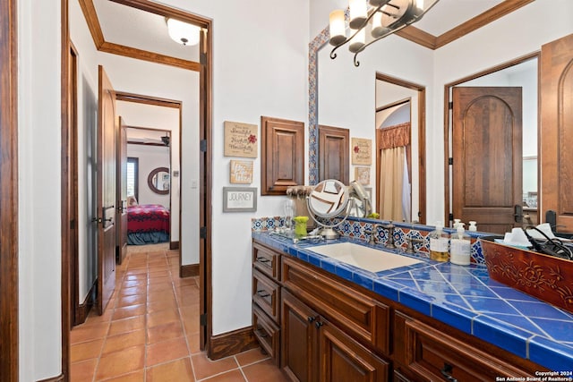 bathroom featuring tile patterned flooring, vanity, and ornamental molding