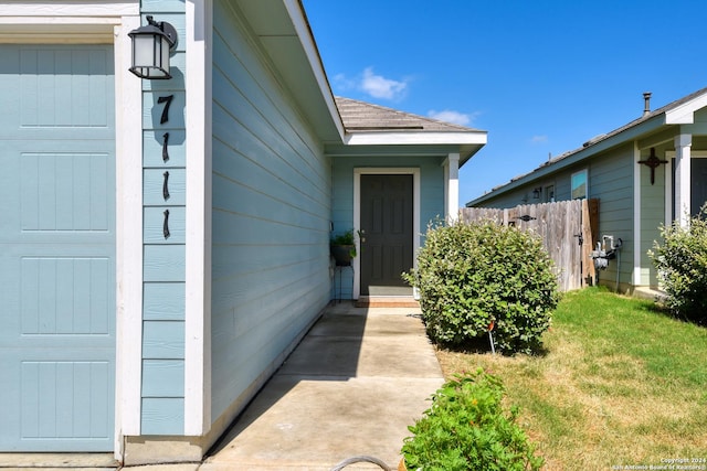 entrance to property with a yard