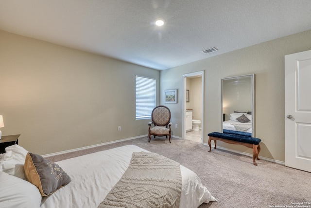 carpeted bedroom with ensuite bathroom