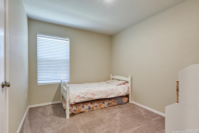 bedroom with light colored carpet