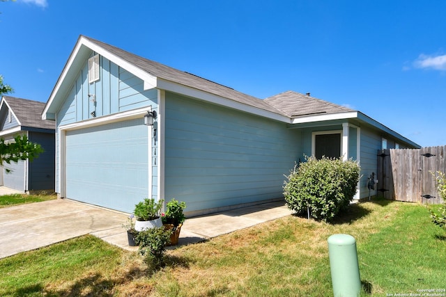 view of side of property with a garage and a yard