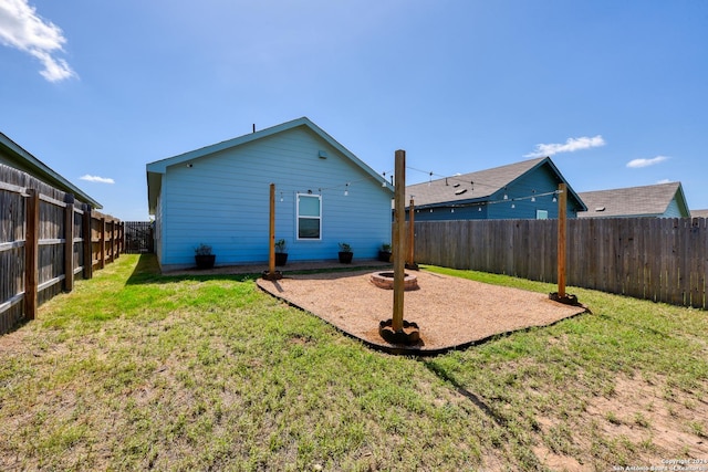 back of house with a lawn