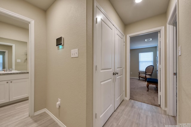 corridor featuring light hardwood / wood-style floors and sink