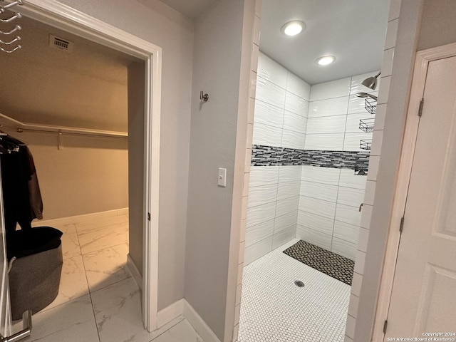 bathroom with tiled shower