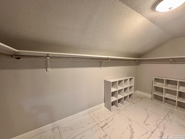 walk in closet featuring lofted ceiling