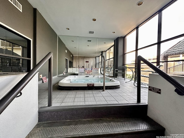 stairway featuring floor to ceiling windows and a healthy amount of sunlight