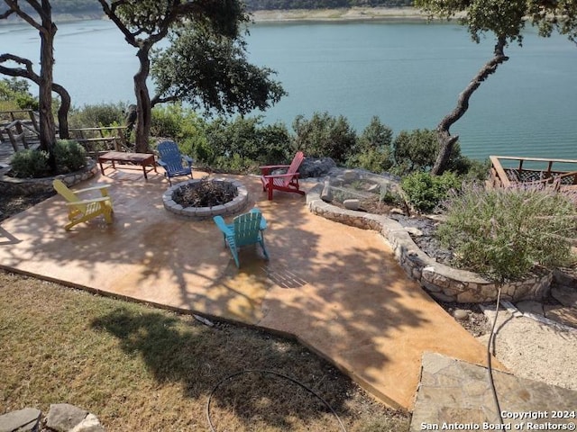 view of patio / terrace with a water view and a fire pit