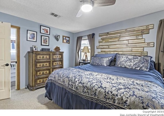 bedroom featuring a textured ceiling, carpet flooring, and ceiling fan