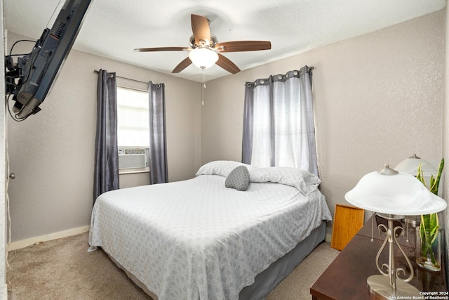 carpeted bedroom with ceiling fan and cooling unit