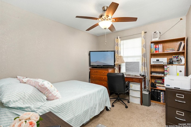 bedroom featuring light colored carpet and ceiling fan