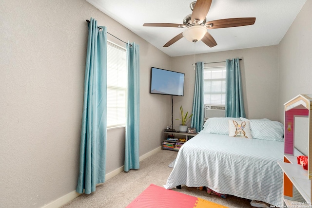 carpeted bedroom with multiple windows, ceiling fan, and cooling unit