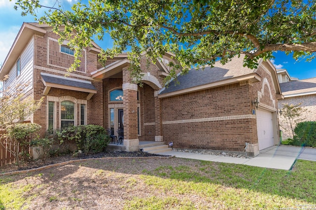 view of front facade featuring a front yard and a garage