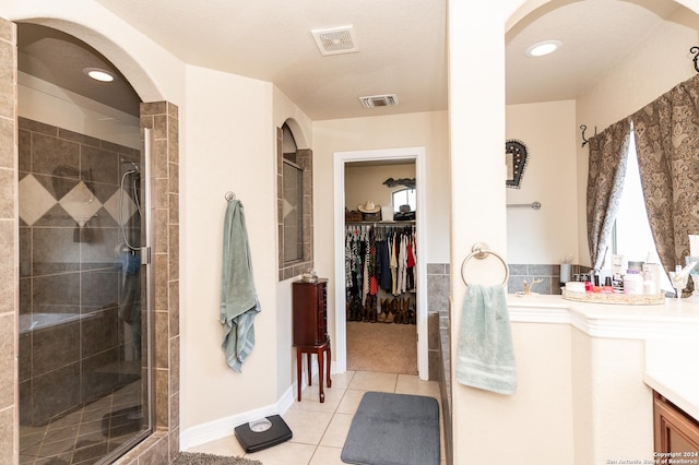 bathroom with tile patterned floors and walk in shower