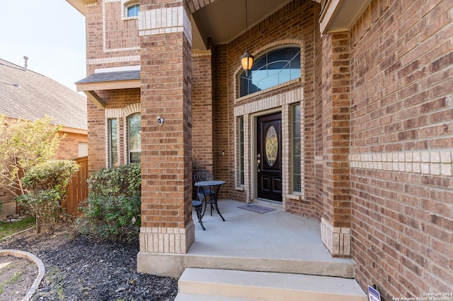 view of exterior entry with covered porch