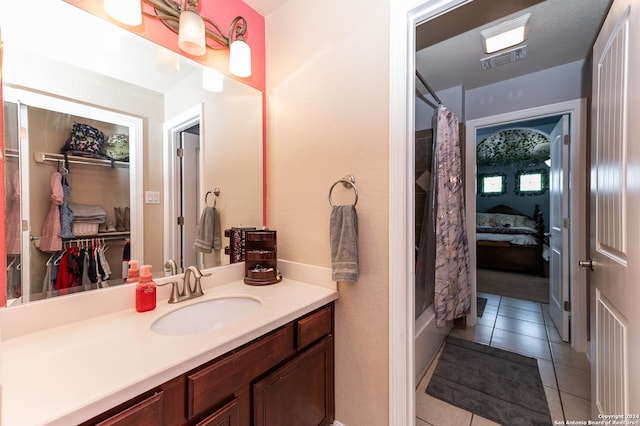 bathroom featuring tile patterned floors, shower / tub combo with curtain, and vanity