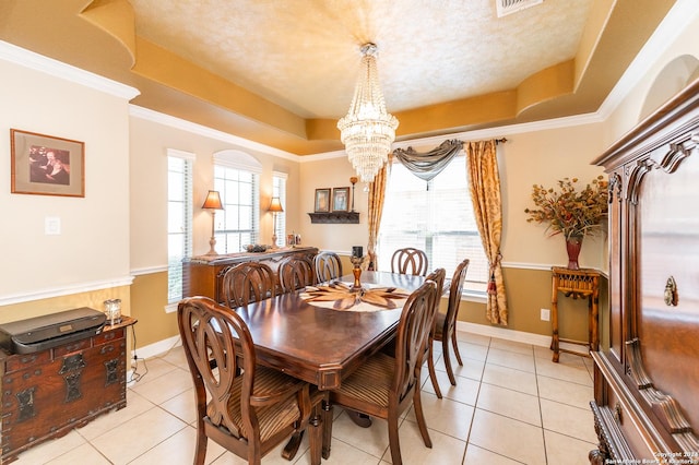 dining room with a notable chandelier, a raised ceiling, and light tile patterned floors