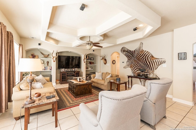 tiled living room with ceiling fan and built in features