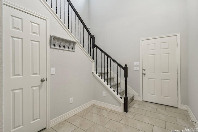 entryway with light tile patterned flooring