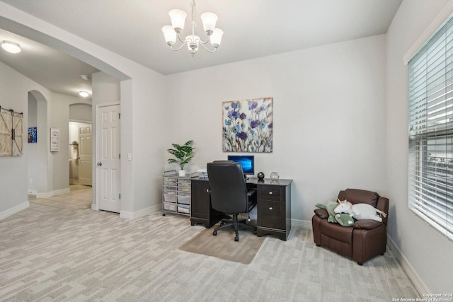 carpeted office with a notable chandelier