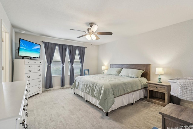 bedroom featuring ceiling fan and light colored carpet