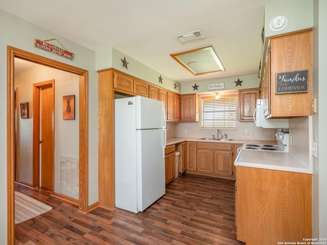 kitchen with sink, white appliances, and dark wood-type flooring