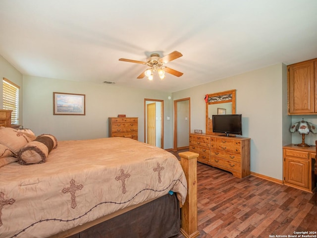 bedroom with ceiling fan and dark hardwood / wood-style flooring