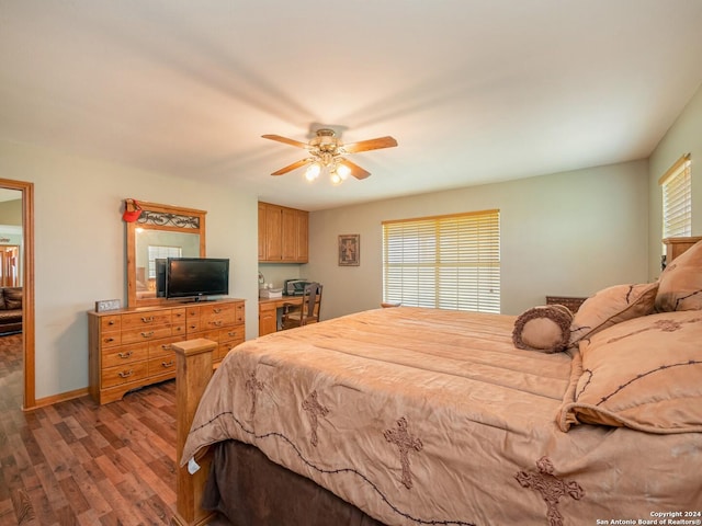 bedroom with ceiling fan and dark wood-type flooring