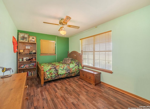 bedroom with ceiling fan and dark hardwood / wood-style flooring