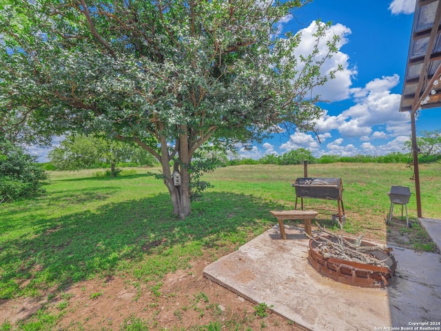 view of yard with an outdoor fire pit